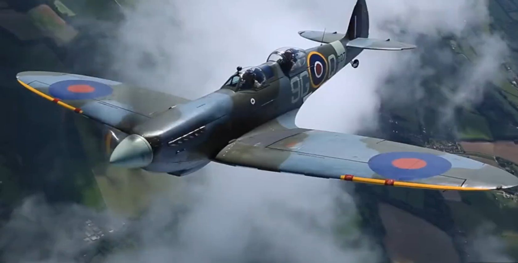 A Supermarine Spitfire in flight above the clouds