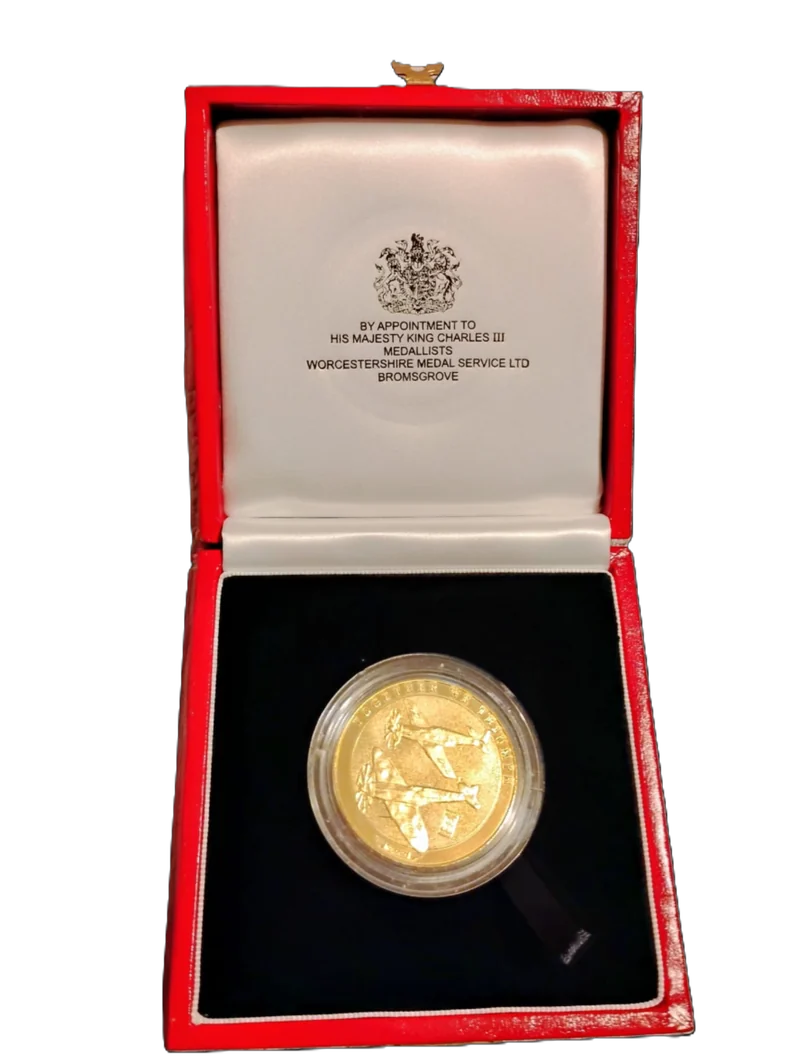 The Tuskegee Airmen coin in its red presentation case